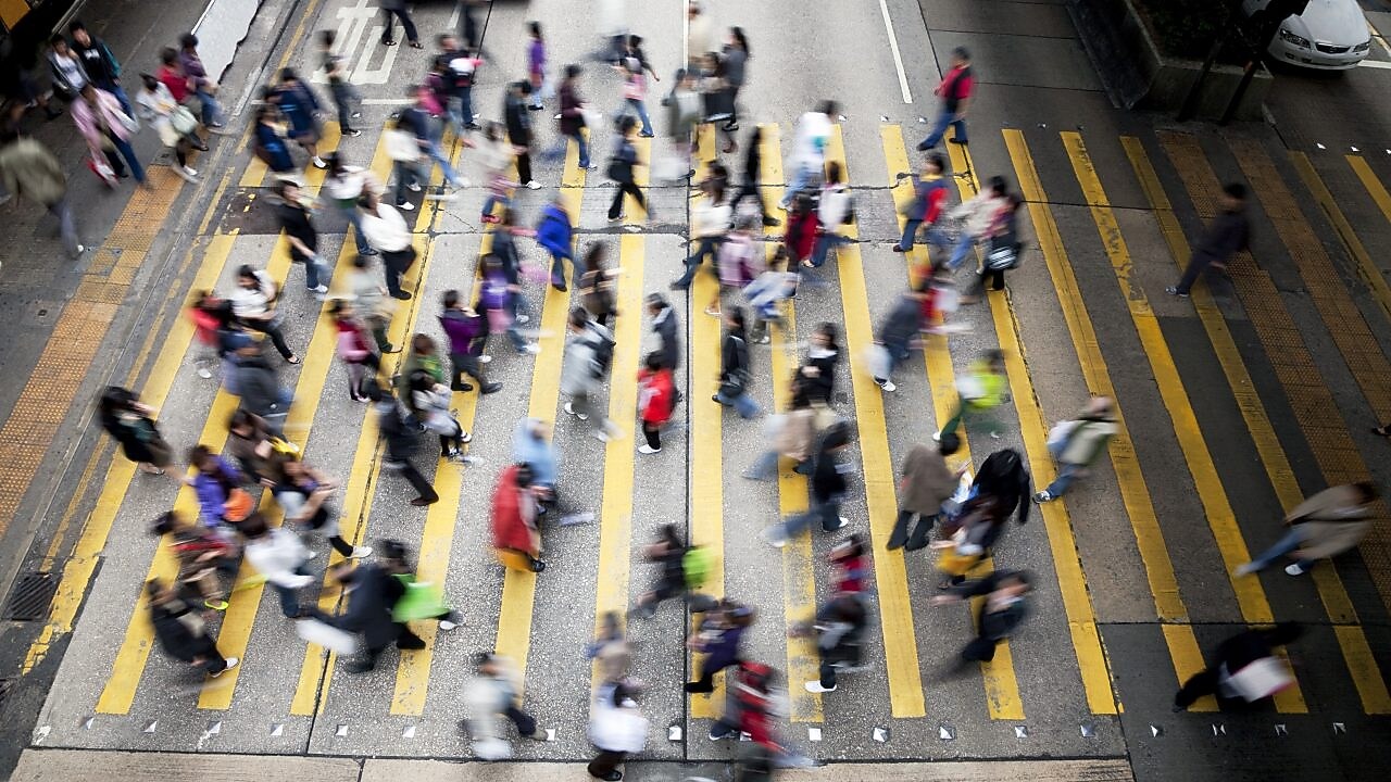 People crossing a busy street in Hong Kong