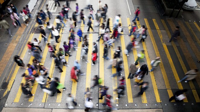 People crossing a busy street in Hong Kong