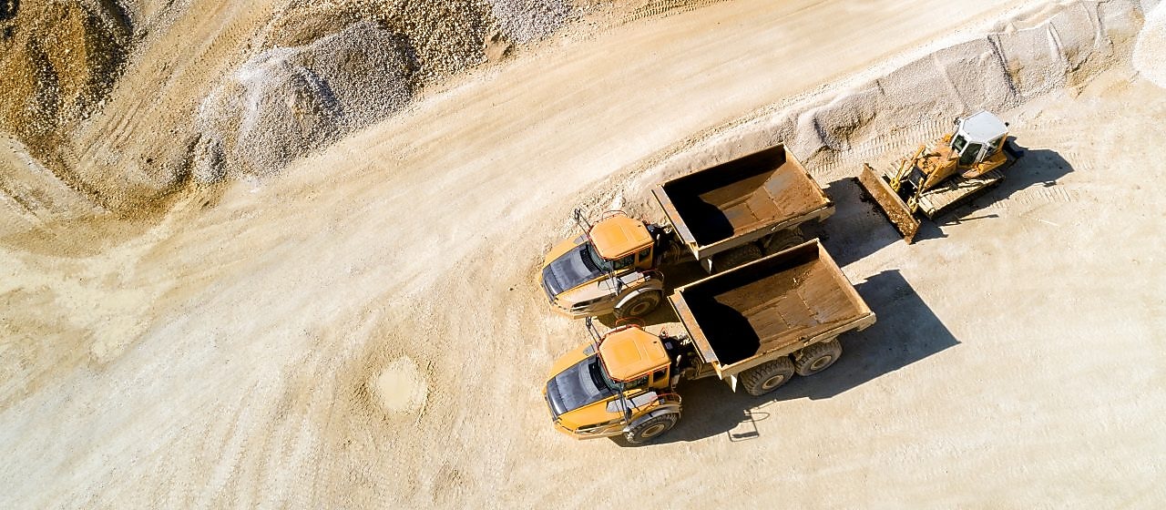 Two mining trucks driving