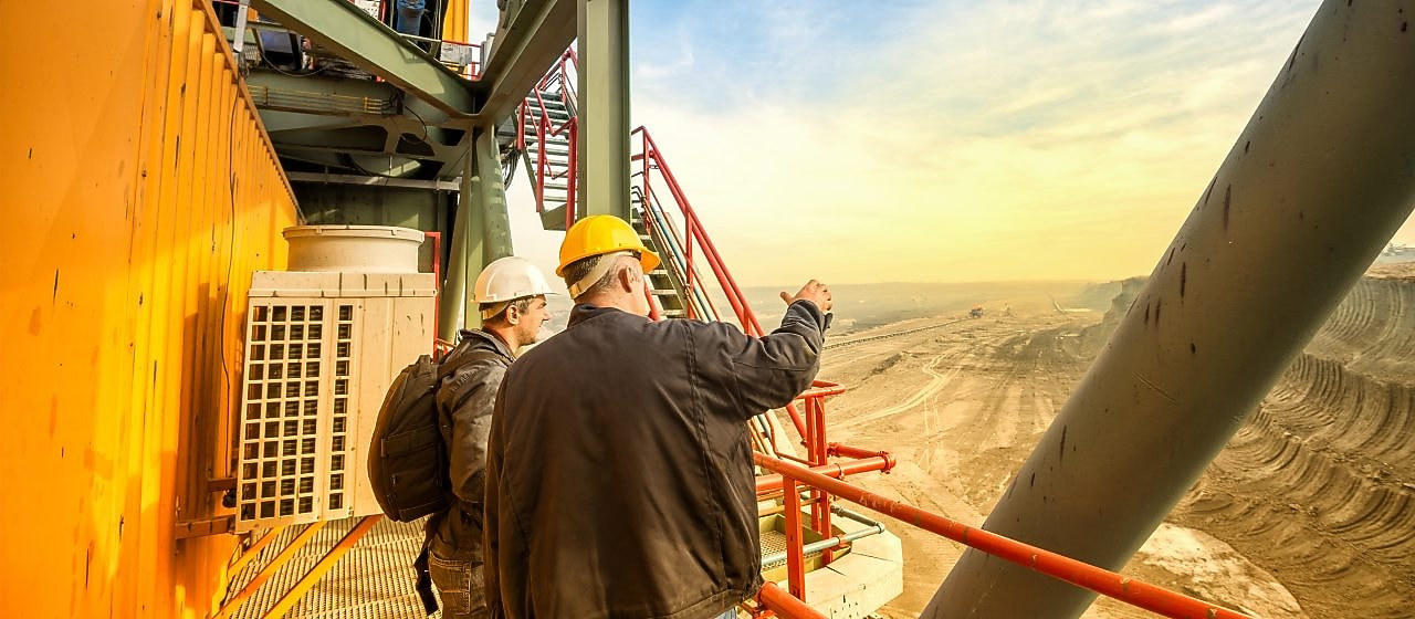 Two Shell employees looking out over a mine
