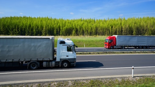 A red and white truck driving towards each other