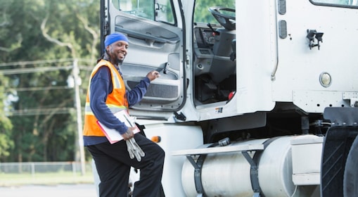 Truck driver stepping into truck