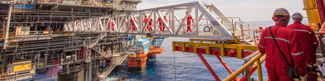 Workers cross over to a new platform built alongside the existing Malampaya deep-water project
