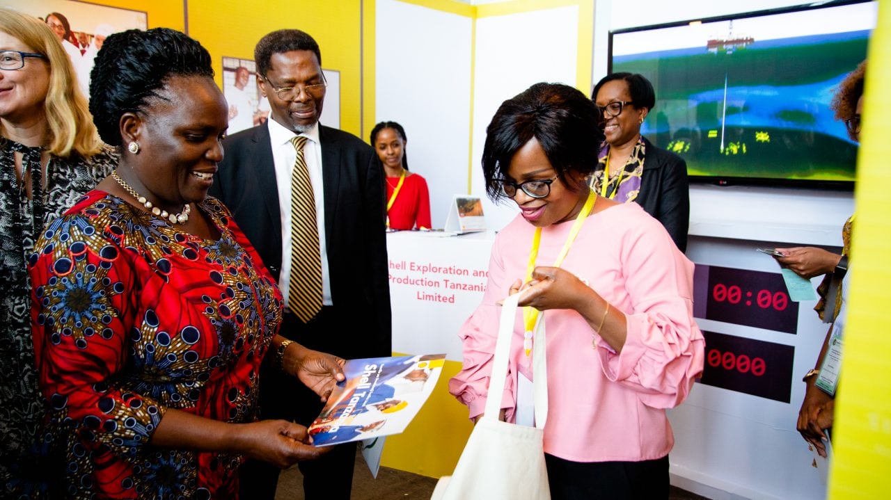 The Guest of Honor admiring the Shell SI Booklet when she visited the Stall