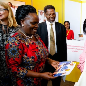 The Guest of Honor admiring the Shell SI Booklet when she visited the Stall