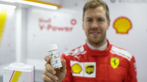 Hands holding a v-power tube on a shell lab