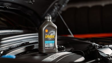 Man holding Shell Helix Ultra bottle